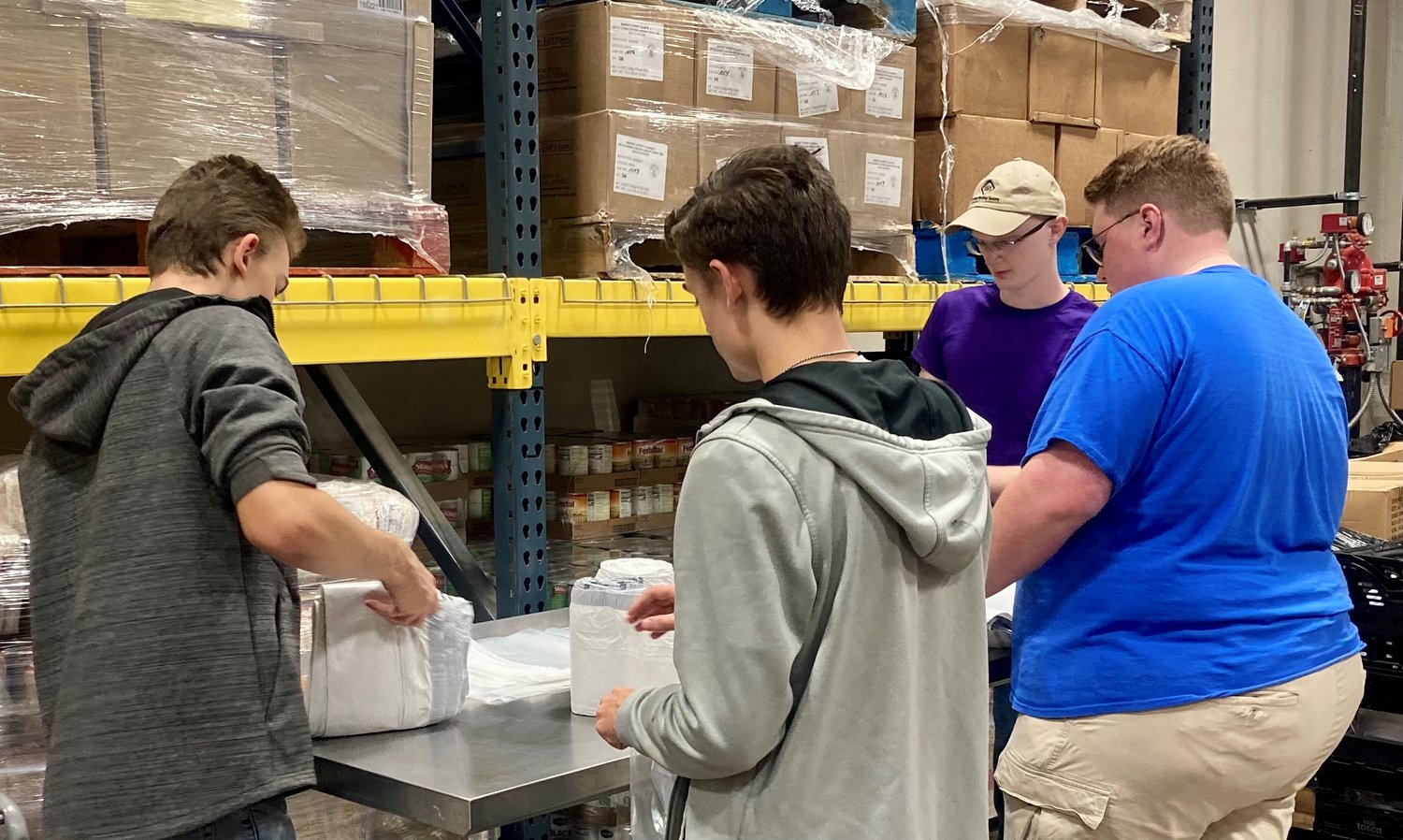 Students from Quincy University in Quincy, Illinois, help out in the food pantry during a service trip to the Catholic Charities Center in Jefferson City in October 2022.